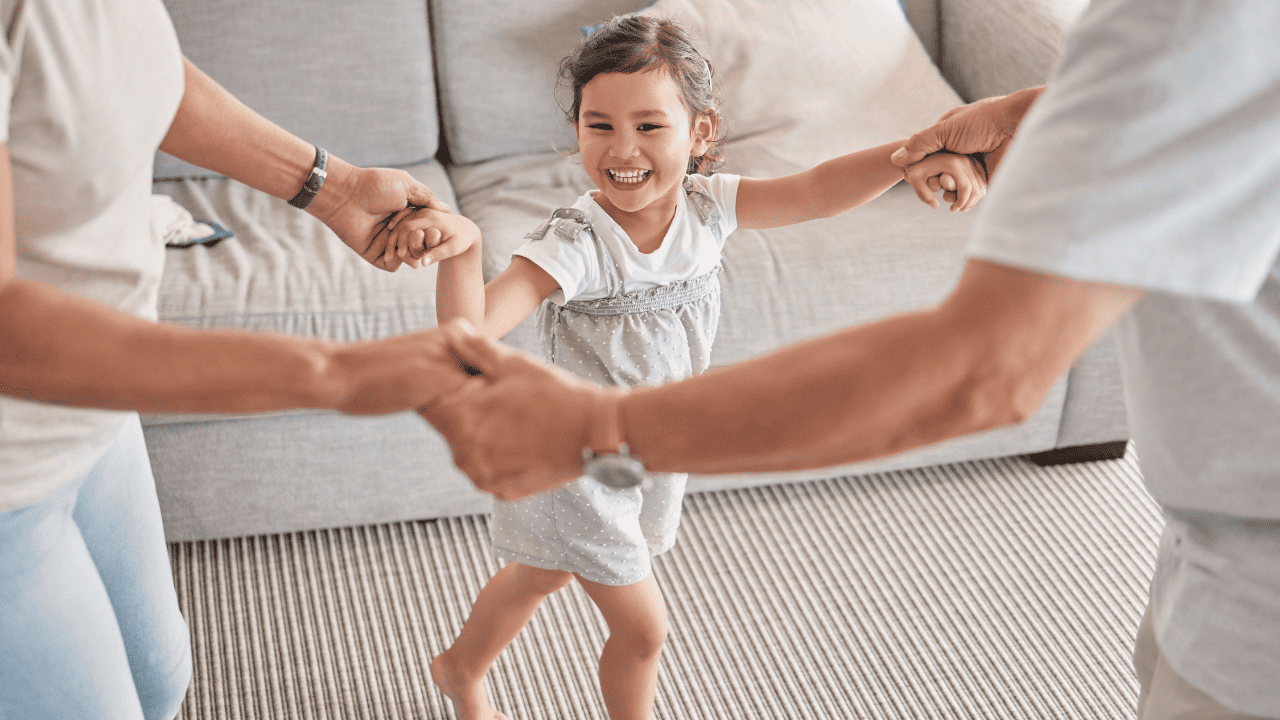 Child dancing with parents